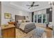 Spacious main bedroom features a tray ceiling, hardwood floors, and a large window at 5309 Overtop Ln, Raleigh, NC 27613