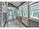 Enclosed sunroom with multiple windows, allowing natural light and outdoor views at 5309 Overtop Ln, Raleigh, NC 27613