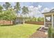 Expansive backyard featuring a modern shed, lush green lawn, and privacy fence at 554 Beacon Ridge Blvd, Chapel Hill, NC 27516