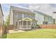 A well-maintained backyard with a cozy screened porch and a charming patio area at 554 Beacon Ridge Blvd, Chapel Hill, NC 27516