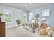 Serene bedroom with natural light, a comfortable bed, and simple decor creates a relaxing and inviting retreat at 554 Beacon Ridge Blvd, Chapel Hill, NC 27516