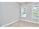 Bright bedroom featuring large windows offering natural light and beige carpet at 554 Beacon Ridge Blvd, Chapel Hill, NC 27516