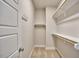 Walk-in closet with carpet features built-in shelving and rods, perfect for organized storage at 554 Beacon Ridge Blvd, Chapel Hill, NC 27516