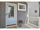 Charming front entrance of home featuring a blue door, gray siding, and a lovely flower pot at 554 Beacon Ridge Blvd, Chapel Hill, NC 27516