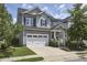 Beautiful two-story home featuring a two-car garage, manicured lawn, and traditional architectural details at 554 Beacon Ridge Blvd, Chapel Hill, NC 27516
