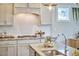 Bright kitchen features granite countertops and stainless steel appliances, and is accented by modern light fixtures and natural light at 554 Beacon Ridge Blvd, Chapel Hill, NC 27516