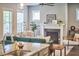 Bright living room with natural light, fireplace, and comfortable seating creates an inviting space for relaxation and entertainment at 554 Beacon Ridge Blvd, Chapel Hill, NC 27516