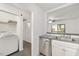 Galley kitchen including a stainless dishwasher and washer dryer connections at 600 Audubon Lake Dr # 4B11, Durham, NC 27713
