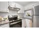 Kitchen features stainless appliances and white cabinets at 600 Audubon Lake Dr # 4B11, Durham, NC 27713