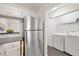 Efficient kitchen design featuring stainless steel refrigerator and washer and dryer in a nook at 600 Audubon Lake Dr # 4B11, Durham, NC 27713