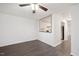 Open-concept living room with hardwood floors, ceiling fan, and pass-through to the kitchen at 600 Audubon Lake Dr # 4B11, Durham, NC 27713