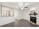 Living room with fireplace and a view of the kitchen through an opening in the wall at 600 Audubon Lake Dr # 4B11, Durham, NC 27713