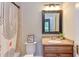 Bathroom features a vanity, toilet, shower with stylish shower curtain and decorative accents at 601 E Franklin St, Raleigh, NC 27604