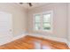 Bedroom features hardwood floors, bright natural light and a ceiling fan at 601 E Franklin St, Raleigh, NC 27604