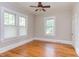 Bedroom features hardwood floors, bright natural light and a ceiling fan at 601 E Franklin St, Raleigh, NC 27604
