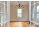 Bright dining room featuring hardwood floors, ample natural light, and classic chandelier at 601 E Franklin St, Raleigh, NC 27604