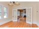 Open dining room with hardwood floors leads to a living room with a fireplace through french doors at 601 E Franklin St, Raleigh, NC 27604