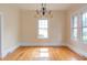 Bright dining room with hardwood floors, natural light, and classic chandelier at 601 E Franklin St, Raleigh, NC 27604