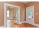 Charming entryway with hardwood floors, decorative glass door, and view to dining area at 601 E Franklin St, Raleigh, NC 27604