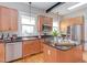 Kitchen with stainless steel appliances, an island, lots of cabinets, and butcher block counters at 601 E Franklin St, Raleigh, NC 27604