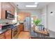 Kitchen with stainless steel appliances, an island, and butcher block counters is well-lit at 601 E Franklin St, Raleigh, NC 27604
