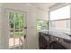 Bright laundry room features modern appliances and plenty of natural light overlooking back yard at 601 E Franklin St, Raleigh, NC 27604