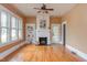 Bright living room featuring large windows, hardwood floors, and a decorative fireplace at 601 E Franklin St, Raleigh, NC 27604