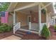 Inviting porch with a ceiling fan, brick accent wall, and outdoor seating area at 601 E Franklin St, Raleigh, NC 27604