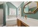 A well-lit bathroom with a combination tub and shower, a modern vanity, and an eye-catching mirror at 601 Texanna Way, Holly Springs, NC 27540