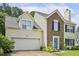 Two-story home featuring a combination of brick and siding, with an attached garage and well-maintained front yard at 601 Texanna Way, Holly Springs, NC 27540