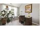 An office area with a functional desk and chair, lush plants, and ample natural light at 601 Texanna Way, Holly Springs, NC 27540