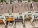 Aerial view of townhomes with patios, individual driveways, and well-maintained landscaping at 6027 Kentworth Drive. Dr, Holly Springs, NC 27540