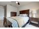 Bedroom with a ceiling fan, bedside tables with lamps, and a bed with blue and white striped bedding at 6027 Kentworth Drive. Dr, Holly Springs, NC 27540