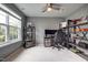 Well-lit bedroom with a large window, desk setup, open shelving, and a comfortable gaming chair at 6027 Kentworth Drive. Dr, Holly Springs, NC 27540