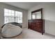 Bedroom featuring a large window, a dark wooden dresser, and a cozy chair with a blanket at 6027 Kentworth Drive. Dr, Holly Springs, NC 27540