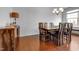 Bright dining room featuring a rustic wood table and chairs under a chandelier at 6027 Kentworth Drive. Dr, Holly Springs, NC 27540