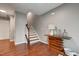 Inviting entryway featuring hardwood floors, staircase, and stylish accent table with decorative items at 6027 Kentworth Drive. Dr, Holly Springs, NC 27540