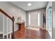 Entryway with hardwood floors, a wooden accent table and front door with sidelights at 6027 Kentworth Drive. Dr, Holly Springs, NC 27540