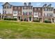 Charming townhomes feature brick and siding exteriors, covered entrances, and well-maintained landscaping at 6027 Kentworth Drive. Dr, Holly Springs, NC 27540