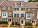 Brick townhome with dormer windows and covered entryway, complemented by manicured landscaping at 6027 Kentworth Drive. Dr, Holly Springs, NC 27540
