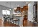 Modern kitchen with stainless steel appliances, granite countertops, pendant lighting, and a breakfast bar at 6027 Kentworth Drive. Dr, Holly Springs, NC 27540