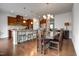 A kitchen features stainless steel appliances, hardwood floors, and a stylish dining table set at 6027 Kentworth Drive. Dr, Holly Springs, NC 27540