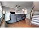 Comfortable living room with a gray sectional, hardwood floors and a fireplace at 6027 Kentworth Drive. Dr, Holly Springs, NC 27540
