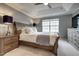 Bright main bedroom featuring neutral colors, a ceiling fan, and natural light from the windows at 6027 Kentworth Drive. Dr, Holly Springs, NC 27540