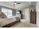 Inviting main bedroom featuring soft carpeting, a tray ceiling, and a dresser with mounted TV at 6027 Kentworth Drive. Dr, Holly Springs, NC 27540