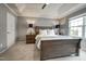 Tranquil main bedroom with a ceiling fan, tray ceiling, and decorative lamps on nightstands at 6027 Kentworth Drive. Dr, Holly Springs, NC 27540