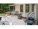 Open back patio features outdoor seating, barbecue grill and manicured garden beds at 603 Edburton Ct, Hillsborough, NC 27278