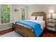 Comfortable bedroom with hardwood floors, large windows, and a bright, airy atmosphere at 603 Edburton Ct, Hillsborough, NC 27278