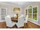 Elegant dining room with hardwood floors, a statement light fixture and big window view at 603 Edburton Ct, Hillsborough, NC 27278