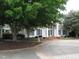 Beautiful white home featuring a brick walkway and meticulously maintained landscaping at 603 Edburton Ct, Hillsborough, NC 27278